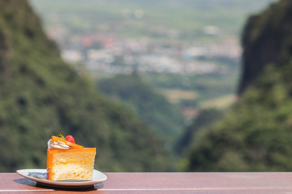 A slice of cake, with a mountain backdrop