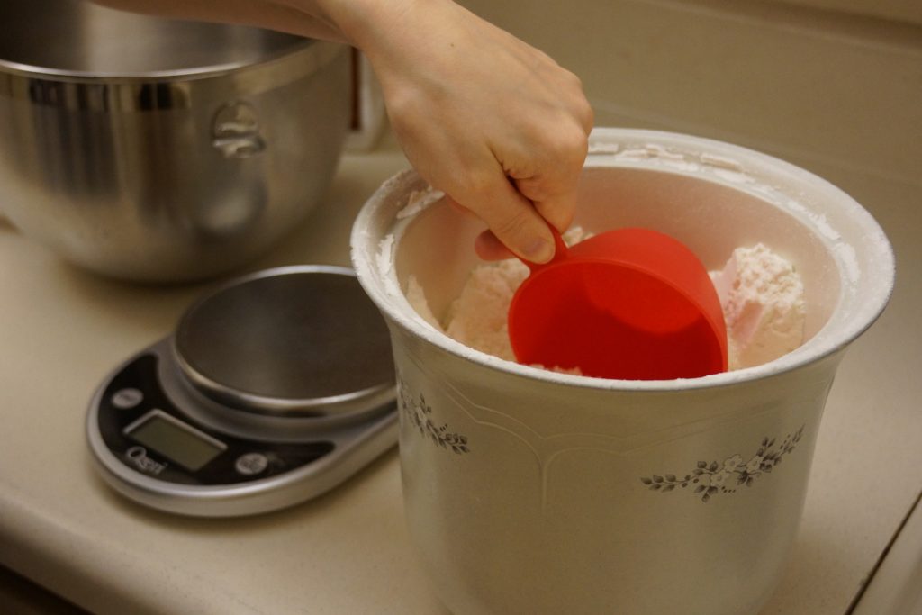 Flour being scooped directly into a measuring cup