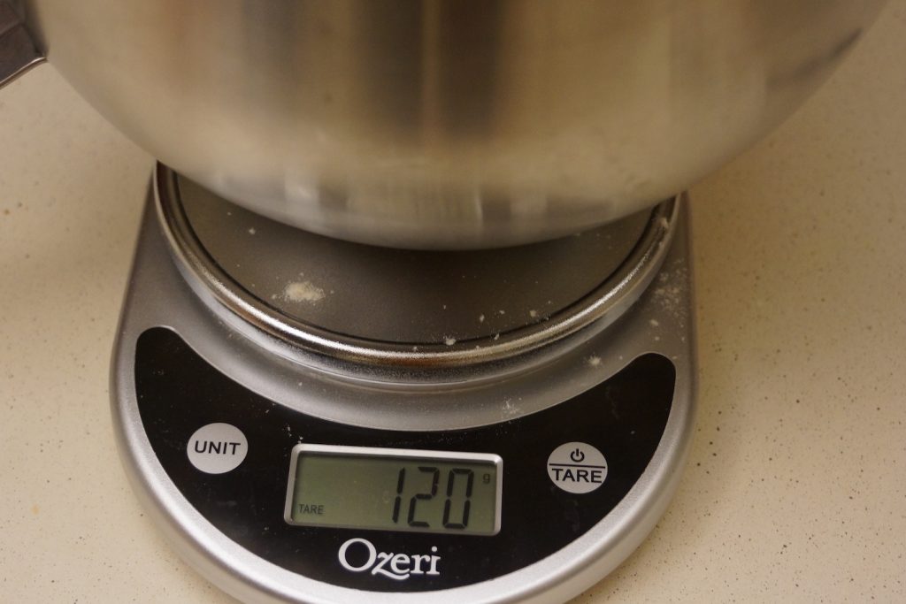 Bowl sitting on a kitchen scale, reading 120 grams.