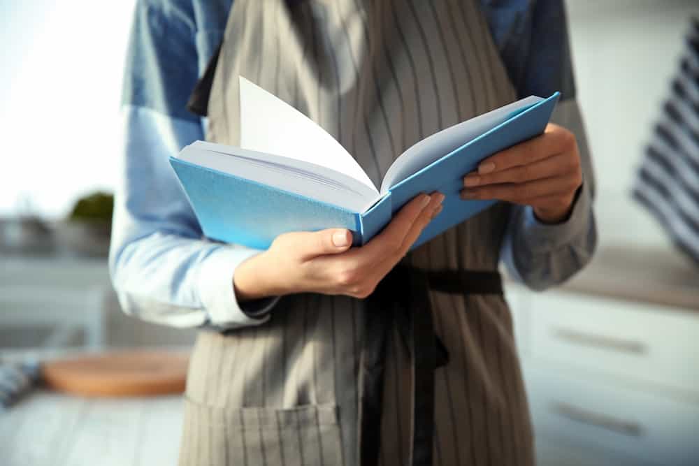 Person reading cookbook