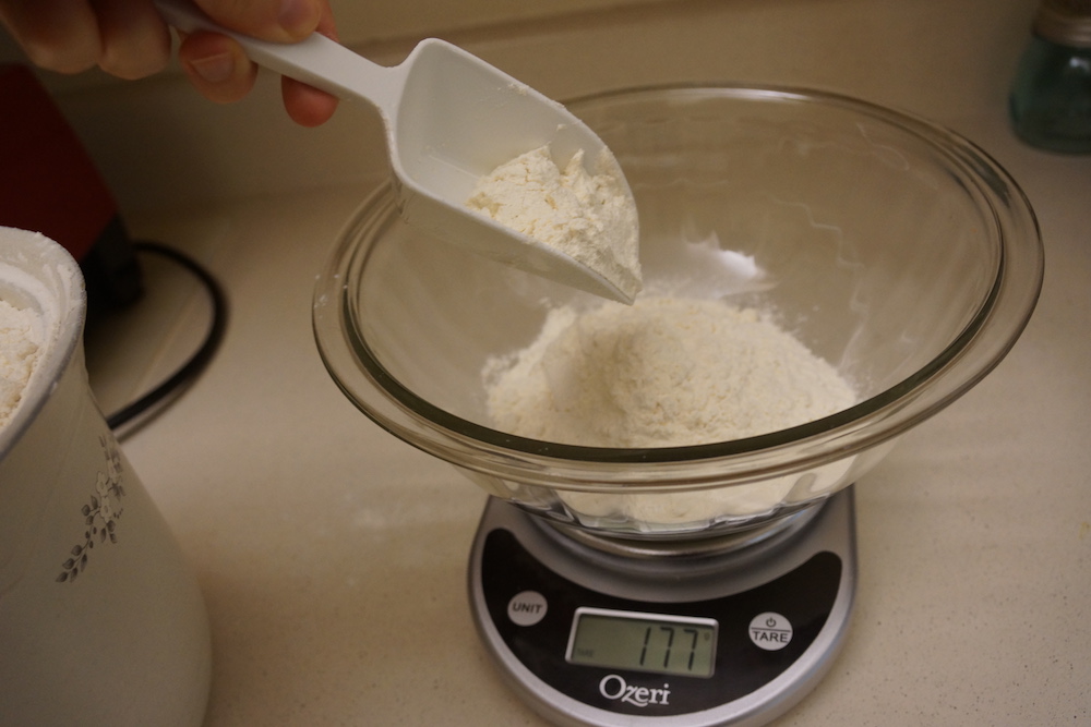 Scooping flour into the bowl